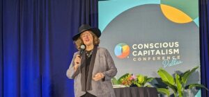 Sam Horn speaking on stage at 2024 Conscious Capitalism Event in Dallas