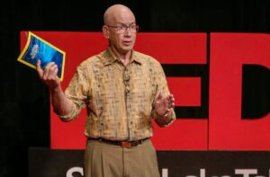 Dewitt Jones on the TED stage with National Geographic Magazine in hand