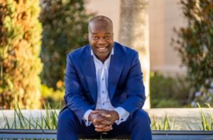 Simon T. Bailey on park bench